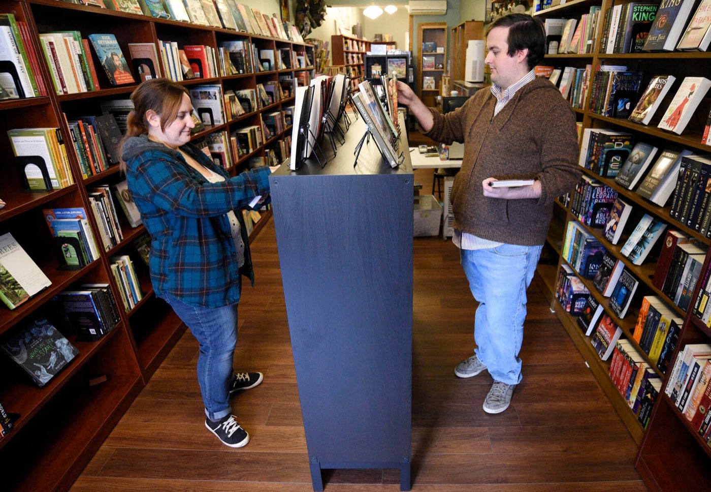 Brad and Becky Carey shelving books between the stacks at The Book Garden